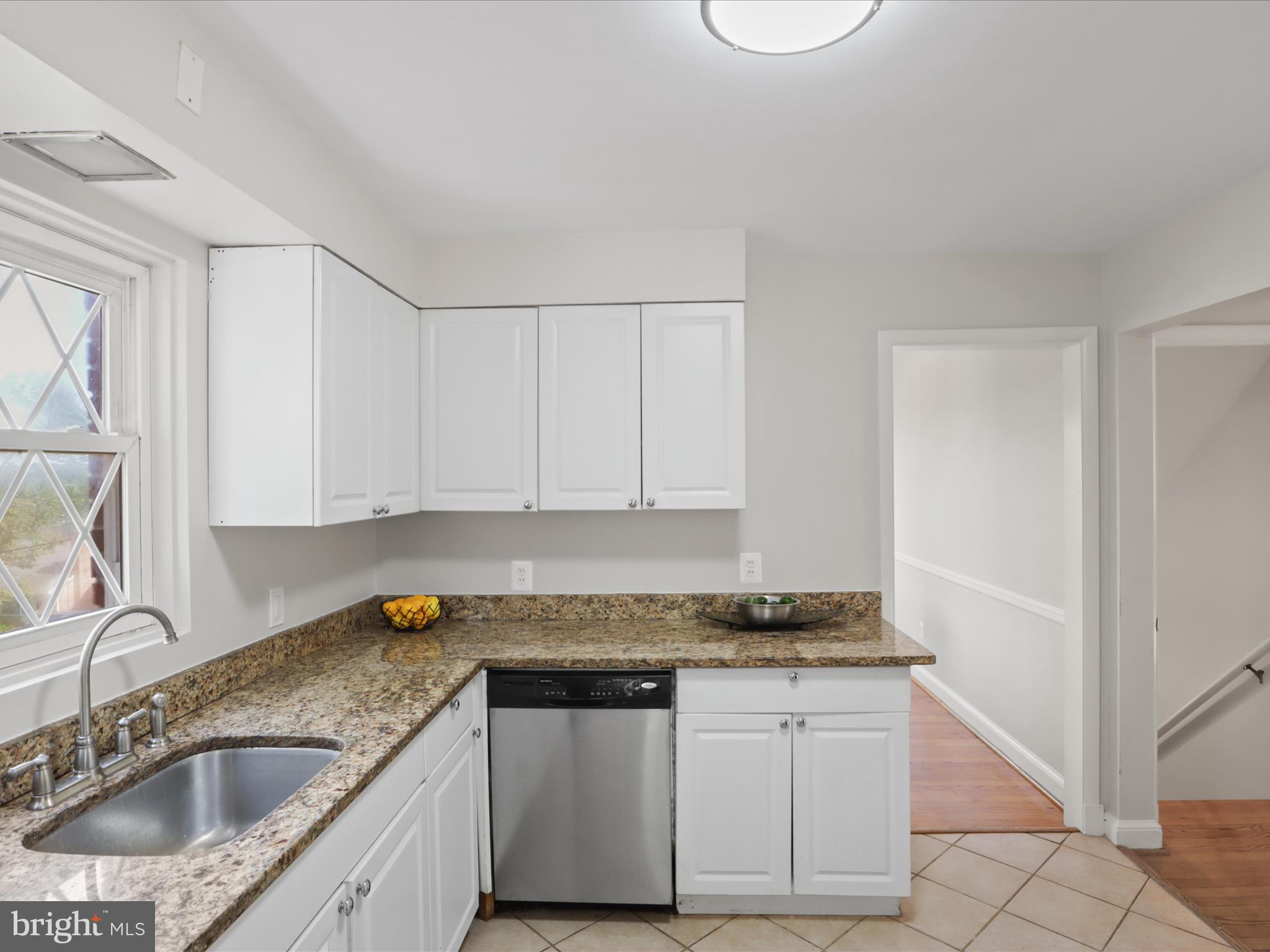 3106 63rd Place Cheverly, MD 20785 - Photo 13 of 42 a kitchen with granite countertop a sink and a stove top oven