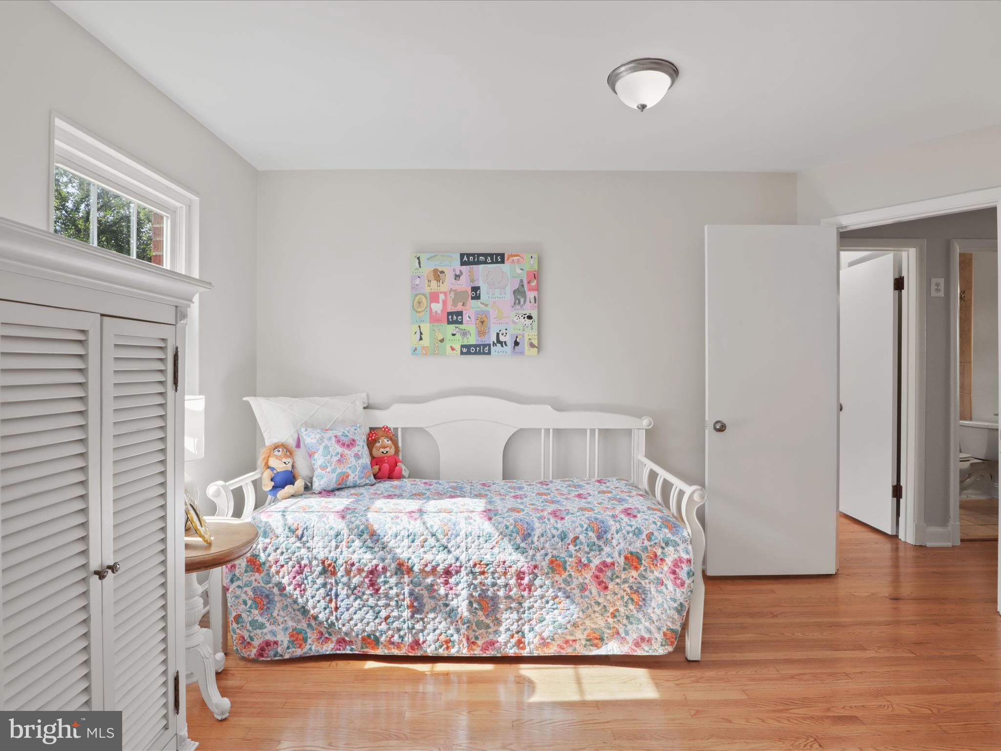3106 63rd Place Cheverly, MD 20785 - Photo 21 of 42 a bedroom with a bed and a painting on the wall
