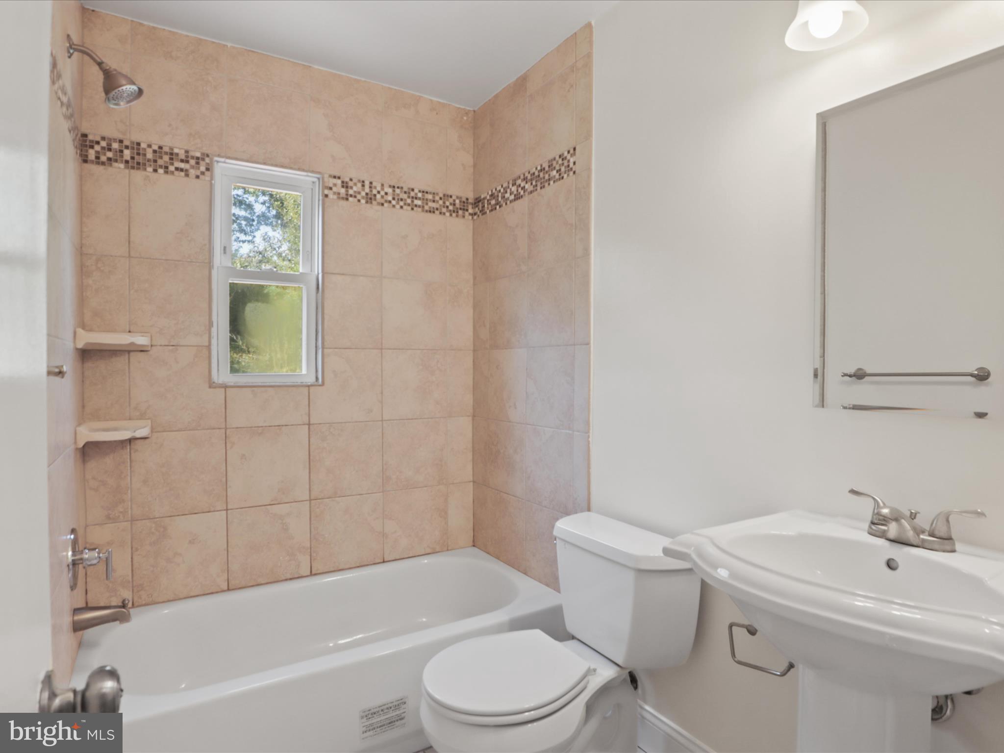 3106 63rd Place Cheverly, MD 20785 - Photo 22 of 42 a bathroom with a sink a toilet and shower