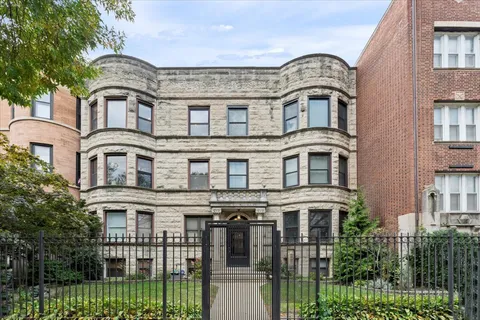 a front view of a residential apartment building with a yard