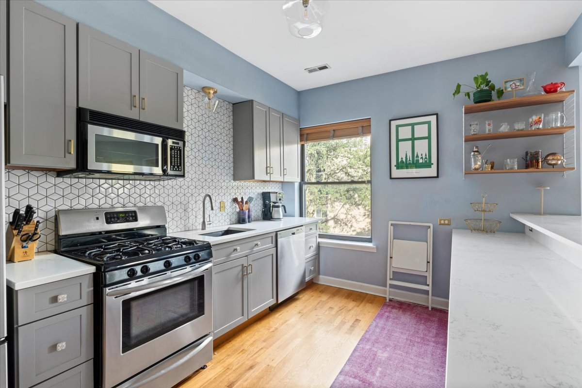5706 North Winthrop Avenue, Unit 3S Chicago, IL 60660 - Photo 14 of 27 a kitchen with cabinets appliances and a window