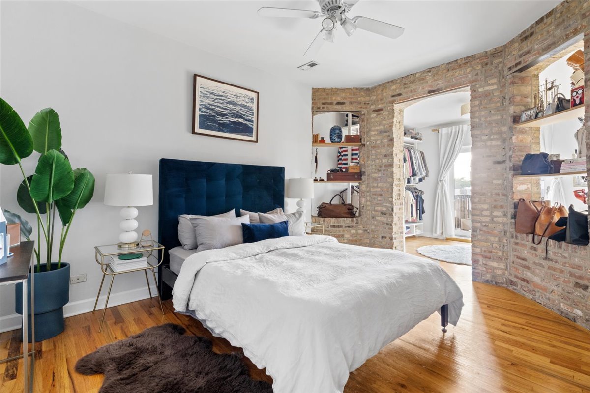 5706 North Winthrop Avenue, Unit 3S Chicago, IL 60660 - Photo 16 of 27 a bedroom with a bed furniture and a potted plant