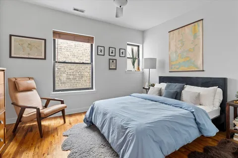 a bedroom with a bed and chair