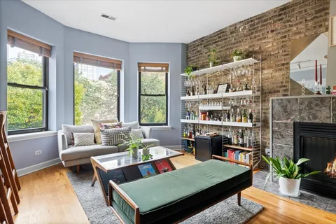 a living room with furniture lamp and a fireplace