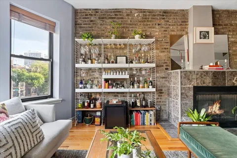 a living room with fireplace furniture and a floor to ceiling window