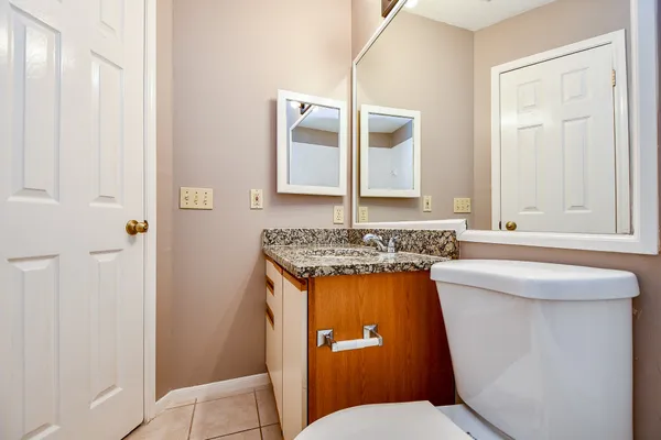 a bathroom with a sink a toilet and a mirror