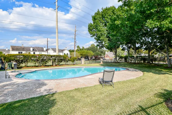 a view of a swimming pool with a yard