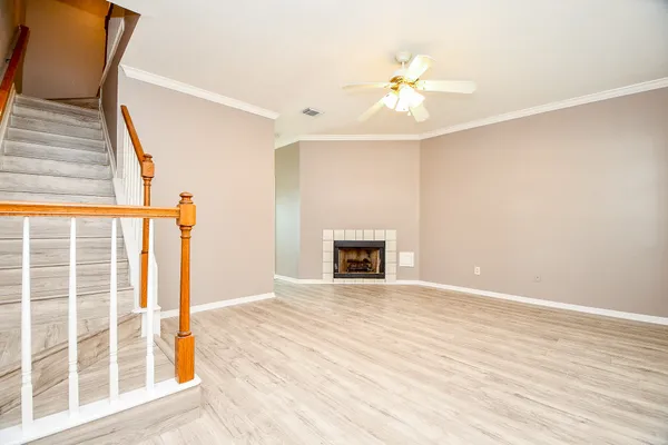 a view of an empty room with a fireplace and a window