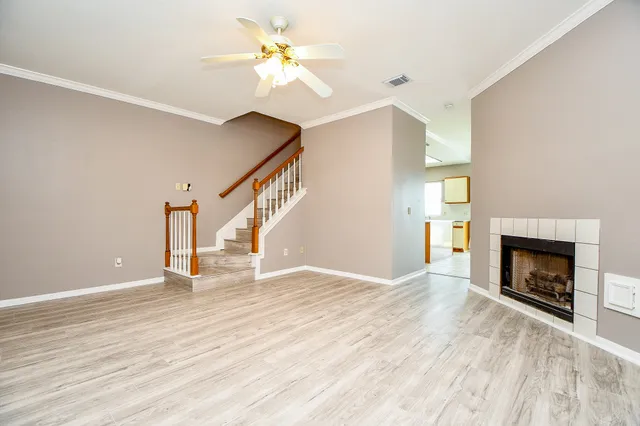 a view of empty room with wooden floor and fireplace