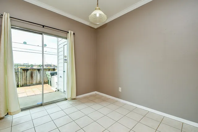 a view of an empty room with glass door