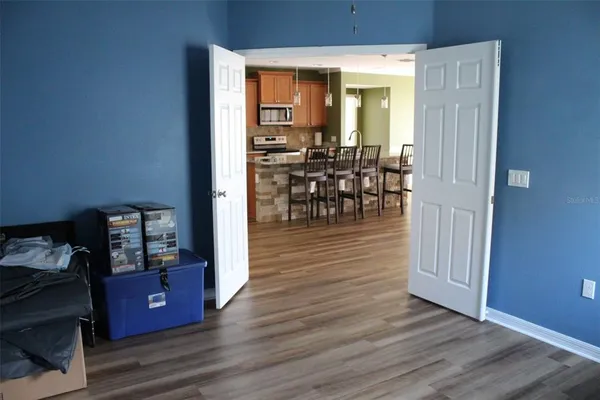 a view of a dining room with furniture and wooden floor