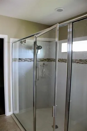 a bathroom with a glass shower door