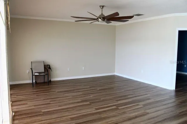 a view of room with wooden floor and a window