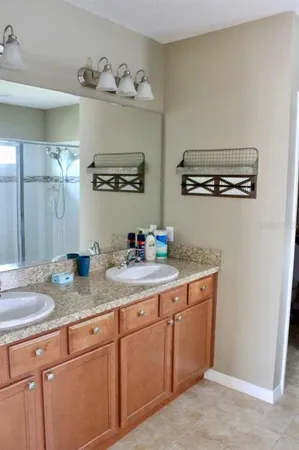 a bathroom with a granite countertop sink and a mirror