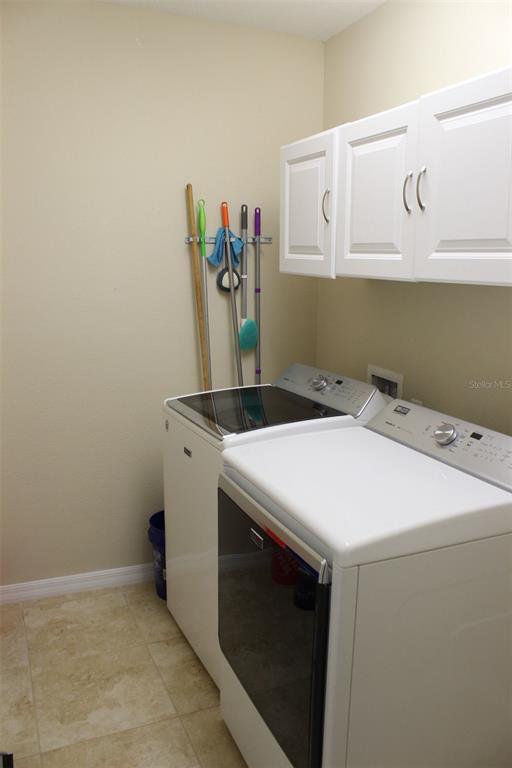 1408 Lanier Point Place Kissimmee, FL 34746 - Photo 25 of 31 a utility room with dryer and washer