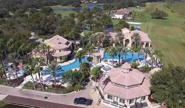an aerial view of a house with outdoor space and lake view