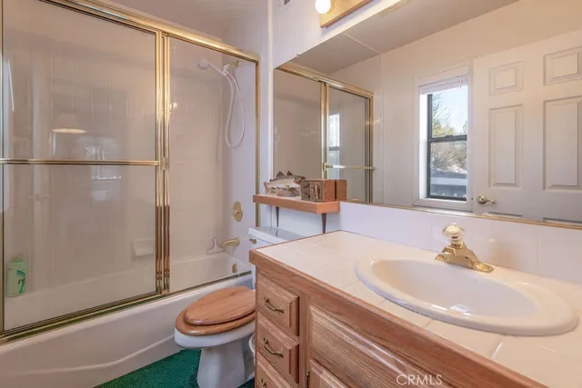 a bedroom with a bed and a lamp on the dresser