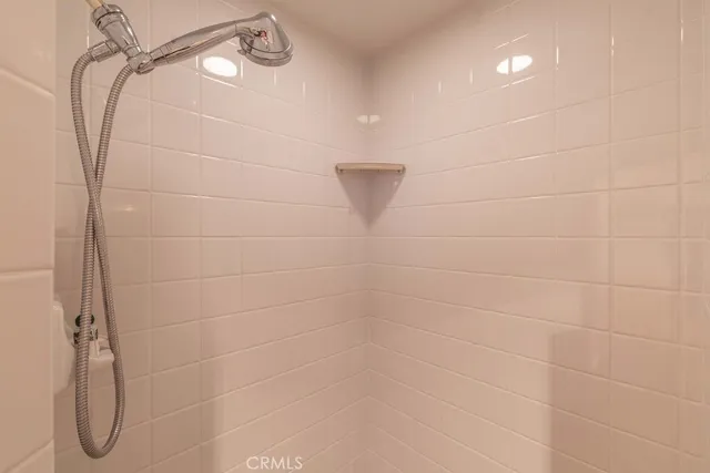 a spacious bedroom with a bed and a painting on the wall