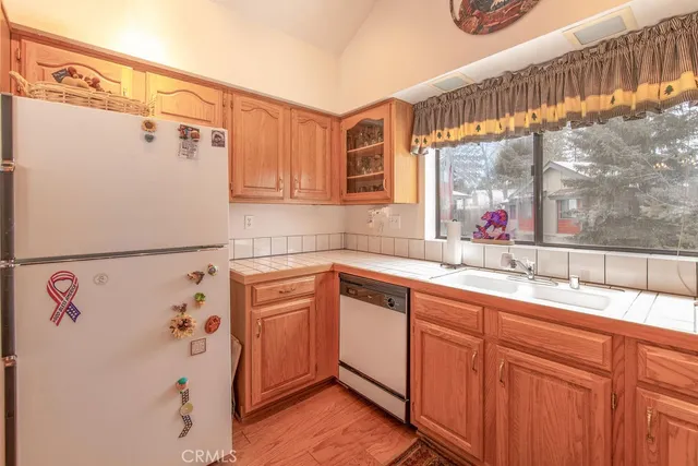 a kitchen with stainless steel appliances a refrigerator and a cabinets