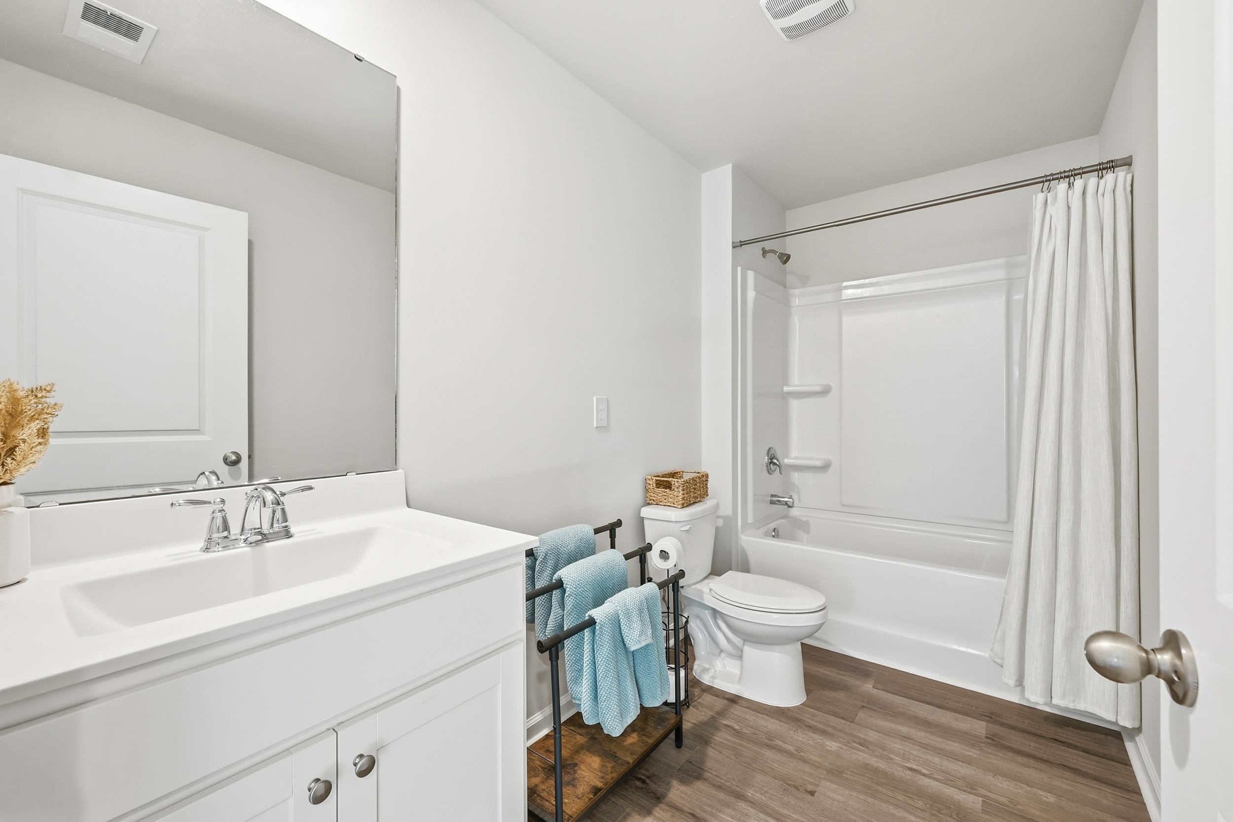 308 Picnic Basket Place Longs, SC 29568 - Photo 28 of 40 Bathroom featuring shower / bathtub combination with curtain, vanity, and dark wood-style floors