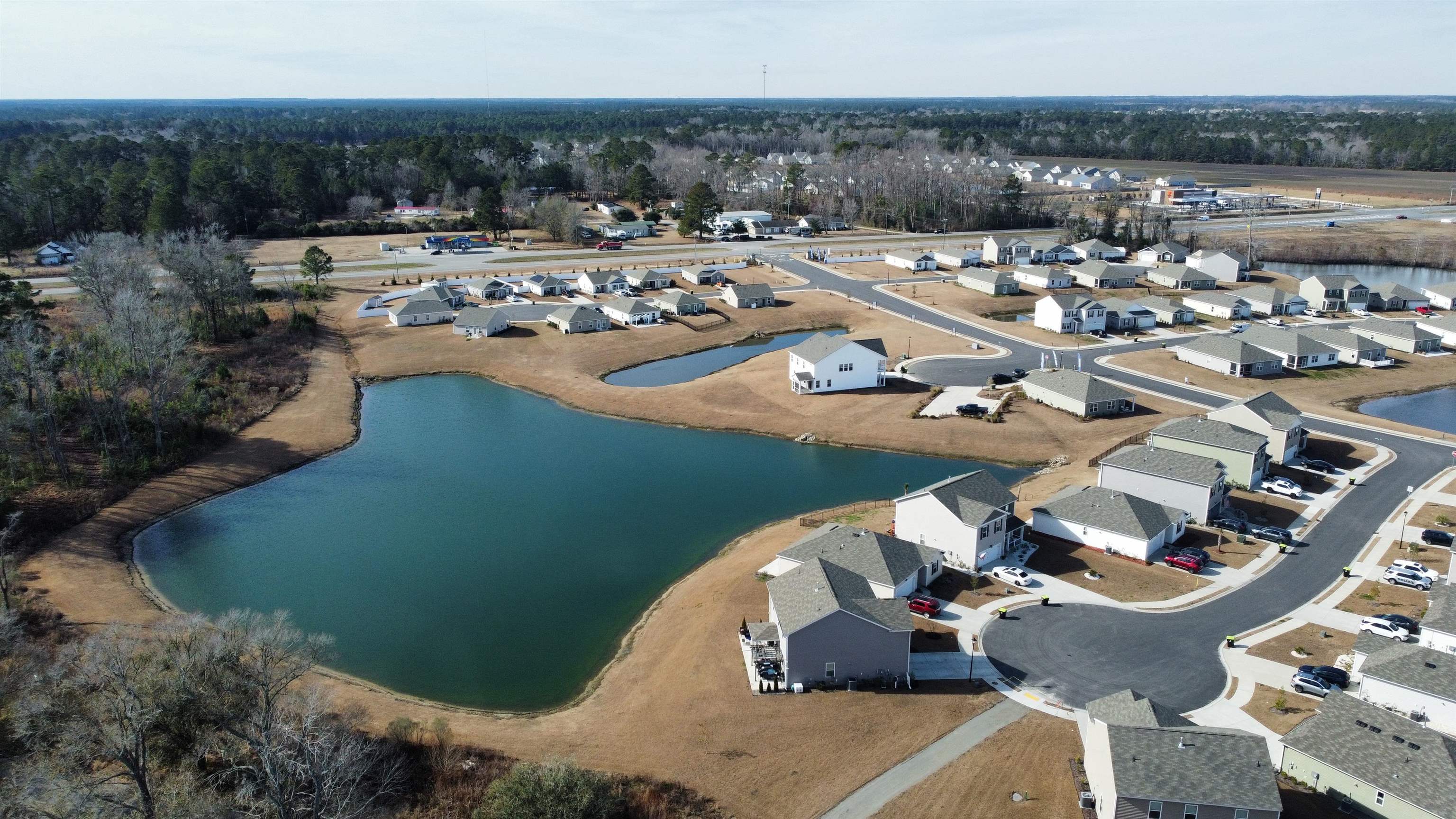 308 Picnic Basket Place Longs, SC 29568 - Photo 37 of 40 Aerial view of property and surrounding area featuring a large body of water and nearby suburban area