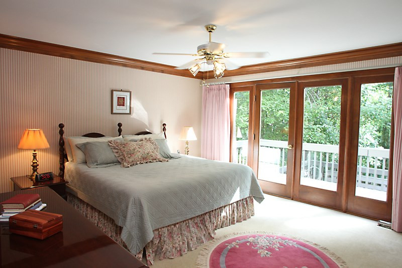 12332 Galway Drive Raleigh, NC 27613 - Photo 13 of 25 Master bedroom on the first floor offers a wall of windows, door access to the deck and backyard area. Master Bedroom