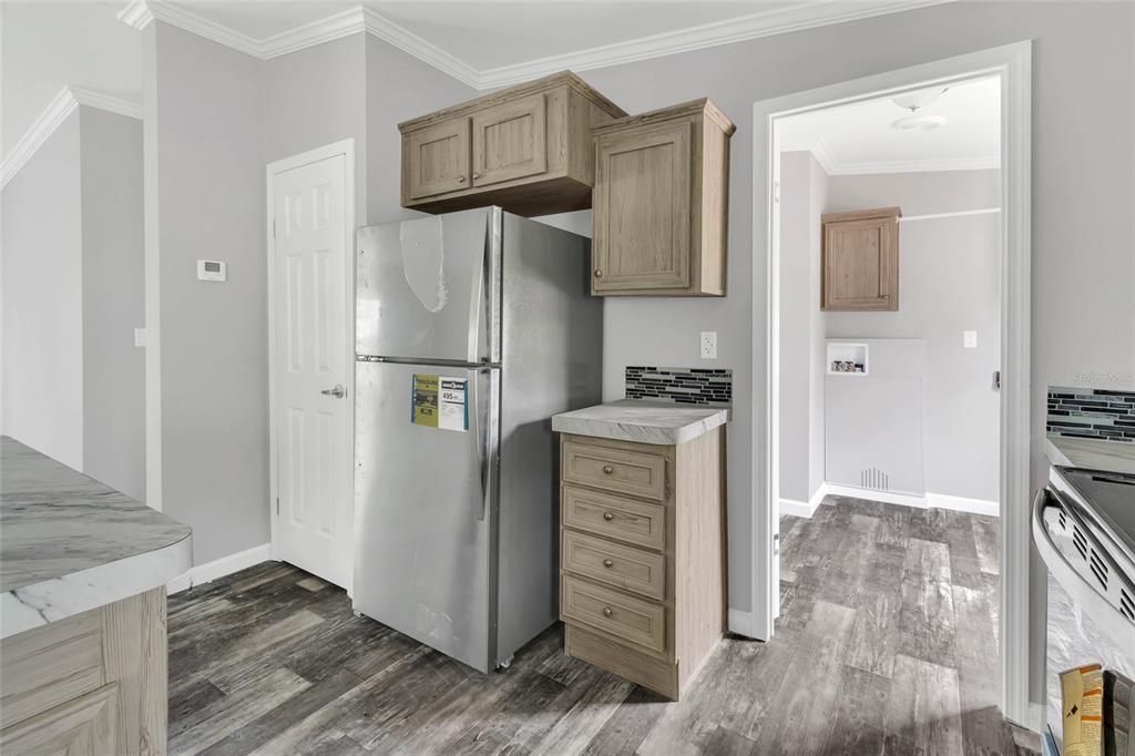 3264 Stephens Boulevard Spring Hill, FL 34606 - Photo 13 of 35 a kitchen with stainless steel appliances a refrigerator and a stove