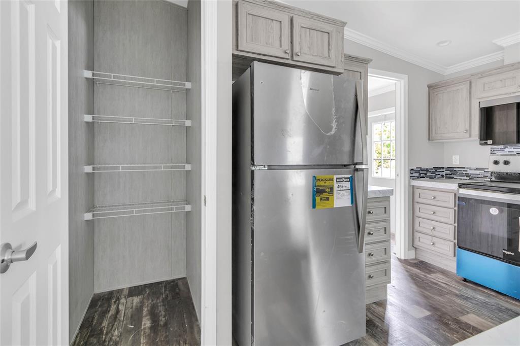 3264 Stephens Boulevard Spring Hill, FL 34606 - Photo 14 of 35 a kitchen with stainless steel appliances a refrigerator and a stove top oven