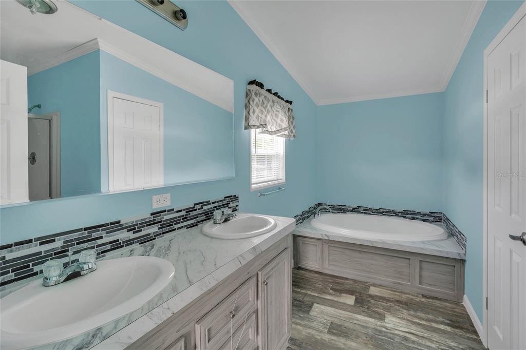 3264 Stephens Boulevard Spring Hill, FL 34606 - Photo 17 of 35 a bathroom with a sink and a mirror