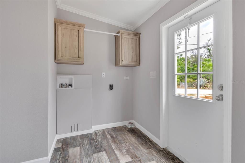 3264 Stephens Boulevard Spring Hill, FL 34606 - Photo 25 of 35 an empty room with wooden floor and windows