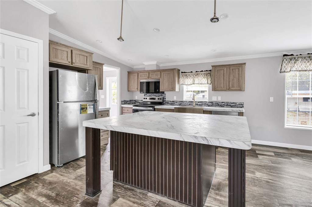 3264 Stephens Boulevard Spring Hill, FL 34606 - Photo 10 of 35 a kitchen with stainless steel appliances granite countertop a refrigerator a sink dishwasher a stove and a refrigerator with wooden floor