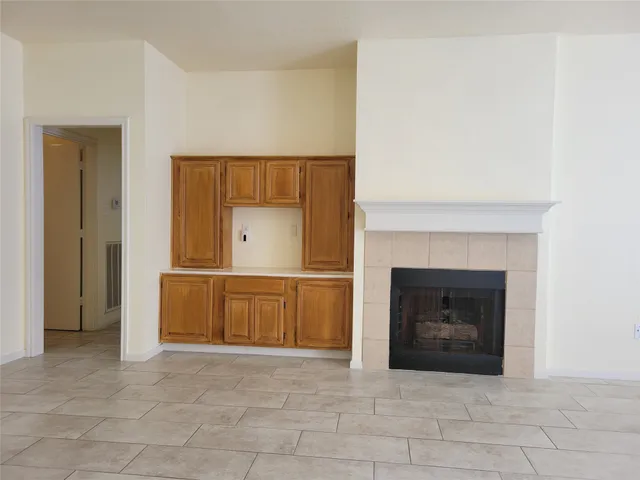 a view of a livingroom with a fireplace and a window