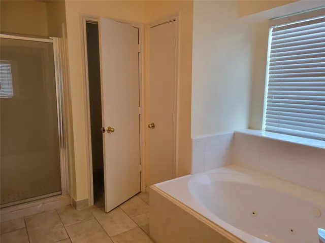 a bathroom with a tub and shower