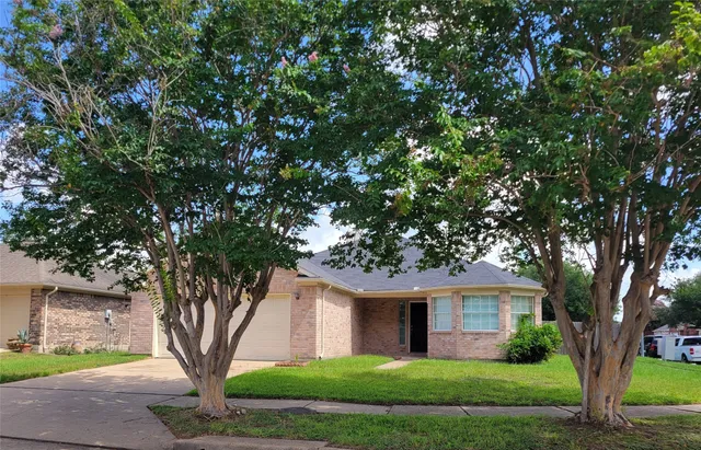 a front view of a house with yard and green space