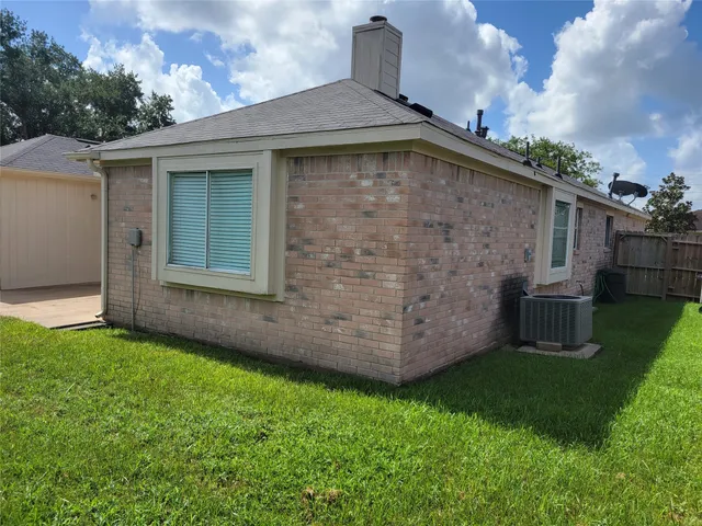 a view of a small house with a yard