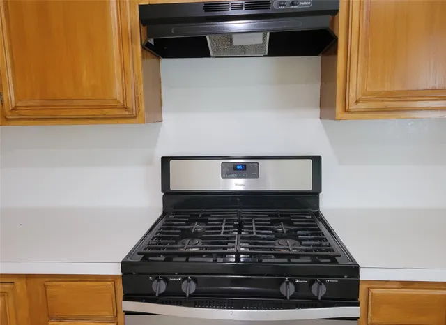 a stove top oven sitting inside of a kitchen