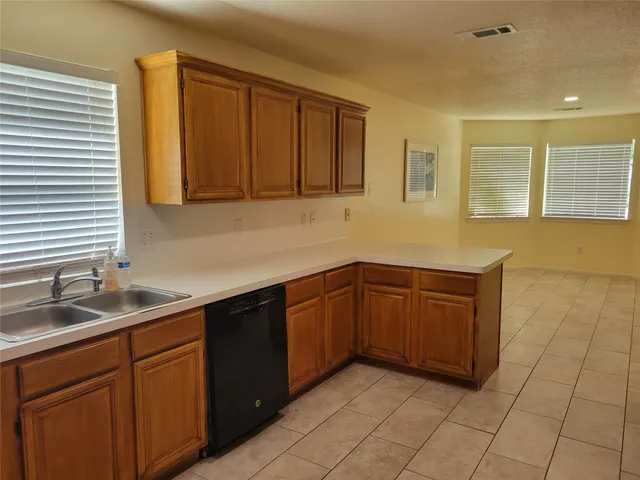 a kitchen with stainless steel appliances granite countertop a sink and cabinets