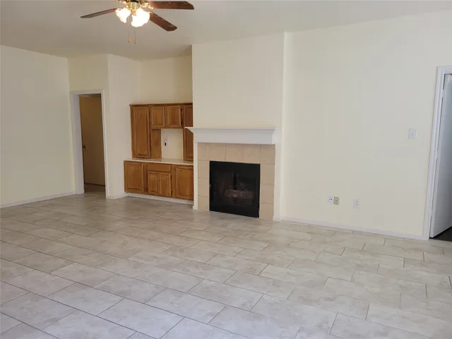 a view of empty room with a fireplace