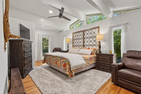a bed room with a bed window and a television