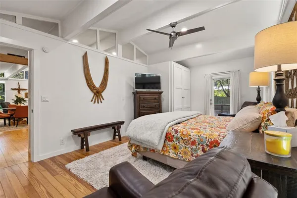 a bedroom with a bed a dresser and chair