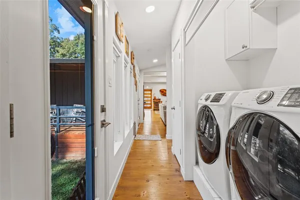 a view of a hallway with washer and dryer