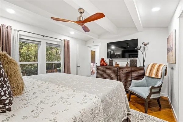a bedroom with furniture and a flat screen tv