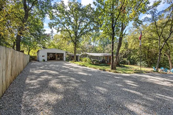 a view of a house with backyard and a tree