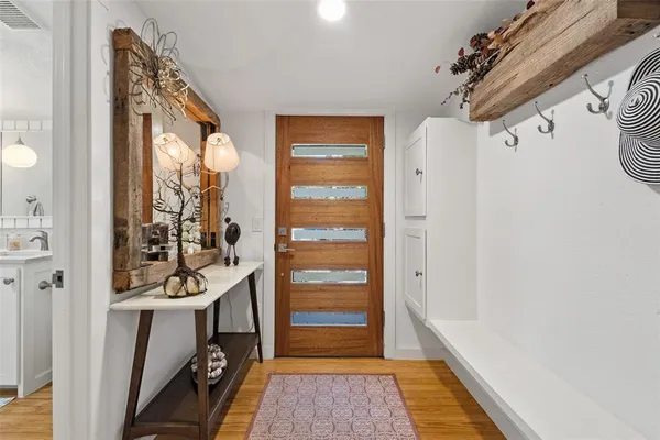 a view of a hallway to a livingroom with furniture