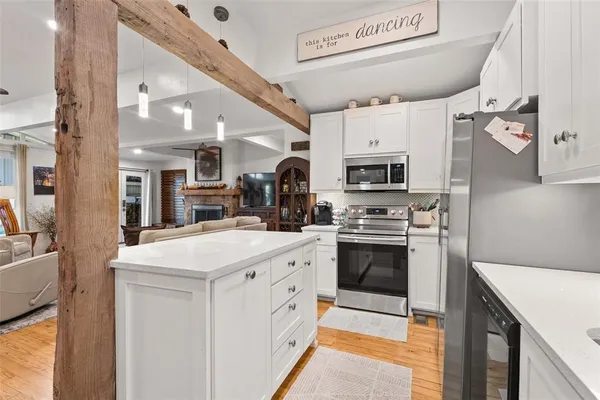 a kitchen with a sink stove and microwave