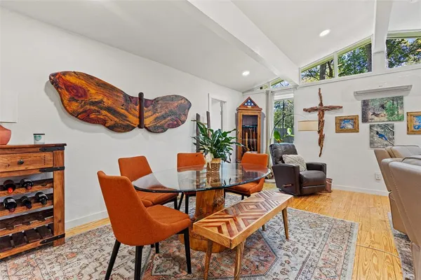 a dining room with furniture and wooden floor