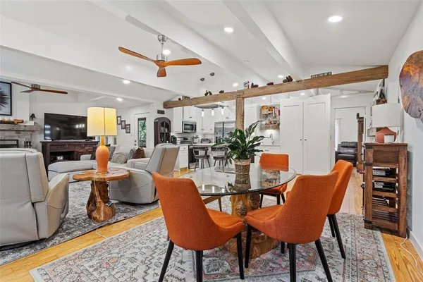 a dining room with furniture and wooden floor