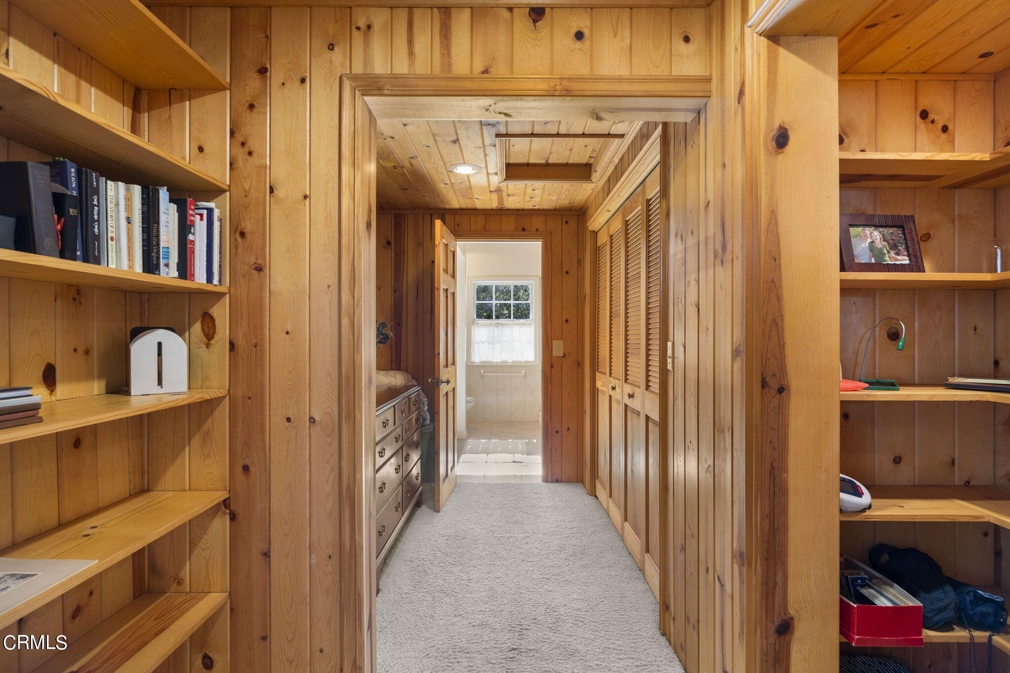 601 Foothill Road Ojai, CA 93023 - Photo 18 of 47 a view of a hallway to a livingroom with wooden floor and windows