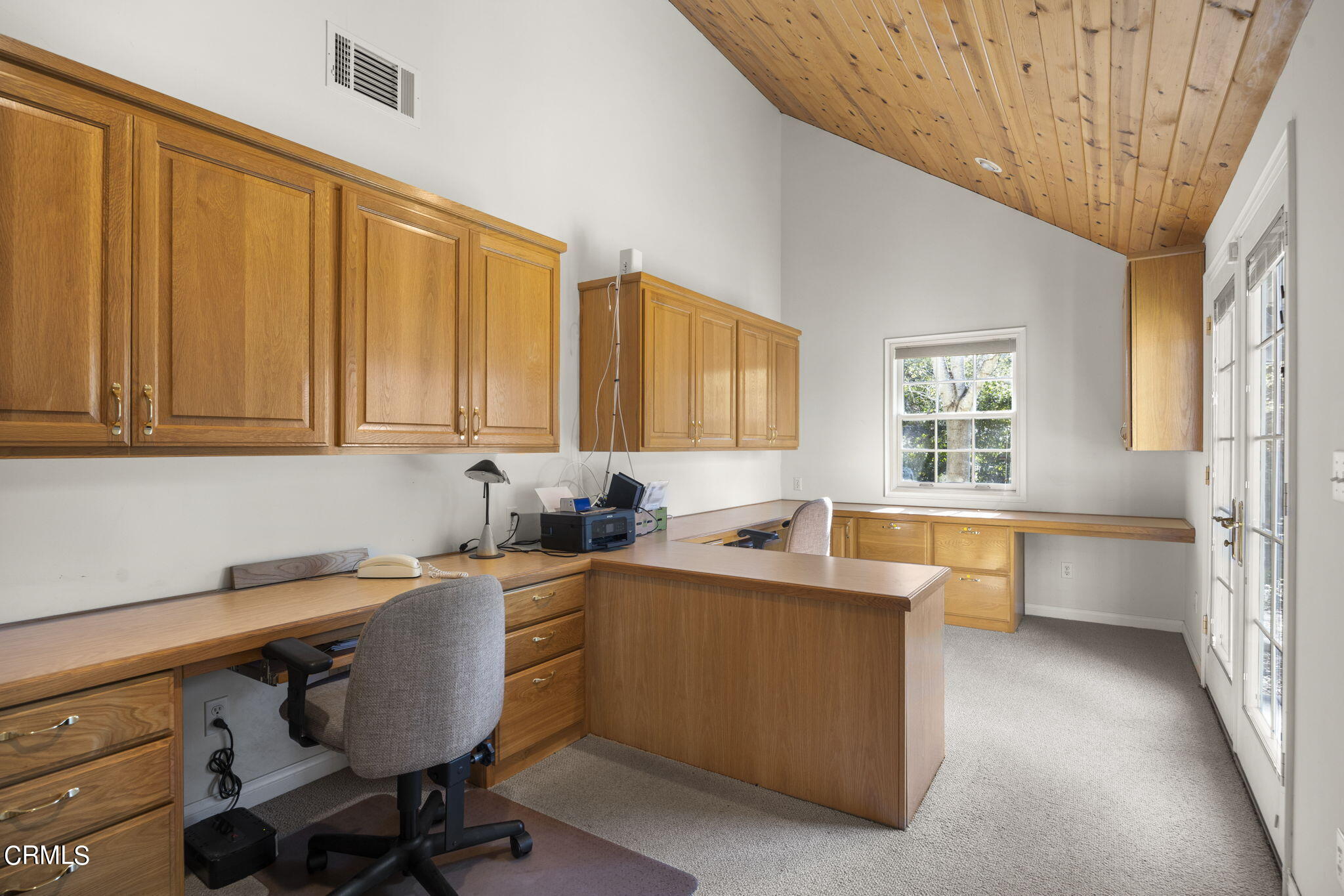 601 Foothill Road Ojai, CA 93023 - Photo 28 of 47 a kitchen with stainless steel appliances a sink a stove and white cabinets with wooden floor