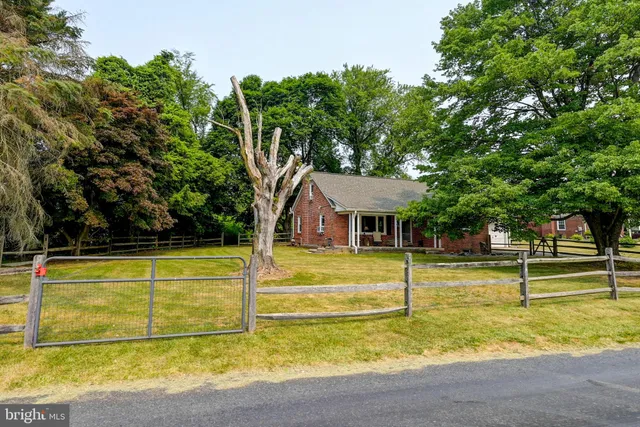 a view of a swimming pool with a lawn chairs under an umbrella